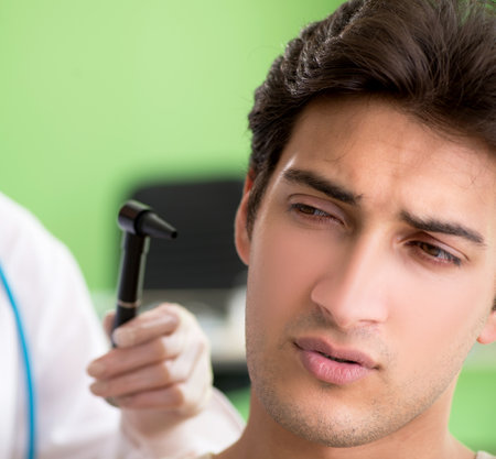 Female doctor checking patients ear during medical examinationの写真素材