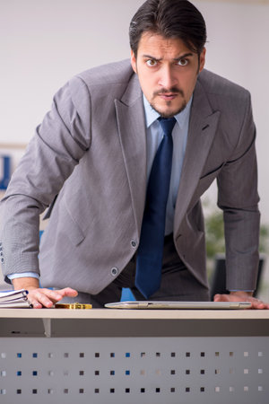 Young male employee working in the officeの写真素材
