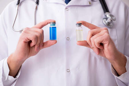 Young male doctor in vaccination concept