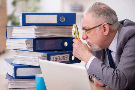 Old male employee unhappy with excessive work in the office