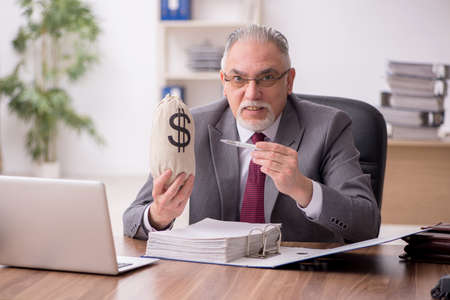Old male employee in remuneration conceptの写真素材