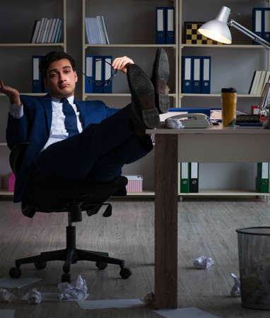 Employee working late to finish important deliverable taskの写真素材