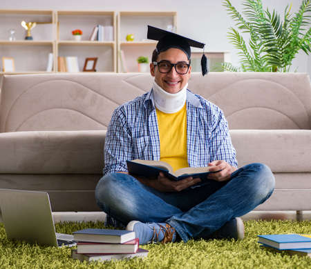 Student with neck injury preparing for examsの写真素材