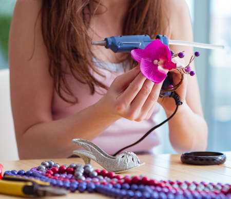 Woman making jewelry at home