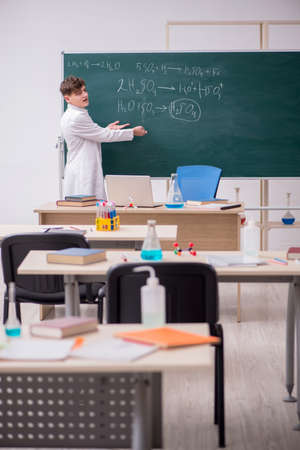 Schoolboy studying chemistry in the classroomの写真素材