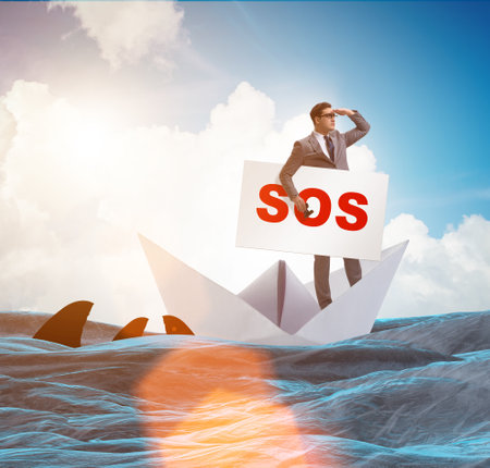 Businessman asking for help with SOS message on boatの写真素材