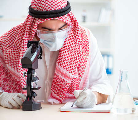 Arab chemist working in the lab officeの写真素材