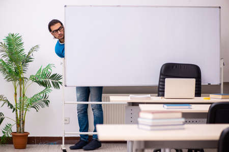 Young male student in the classroomの写真素材