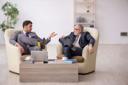 Two businessmen discussing project at workplaceの写真素材