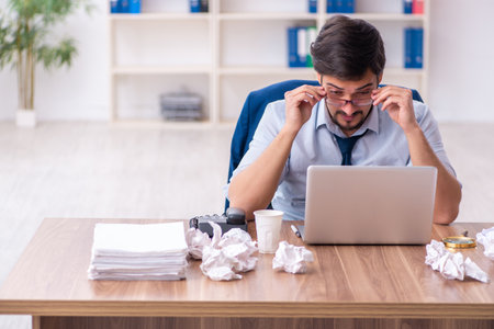 Young male employee rejecting new ideas in the officeの写真素材