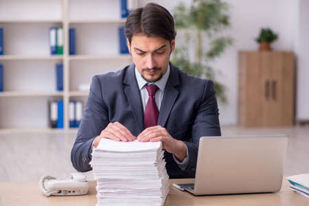 Young male employee working in the officeの写真素材