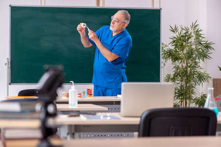 Old male doctor dentist in the classroomの写真素材