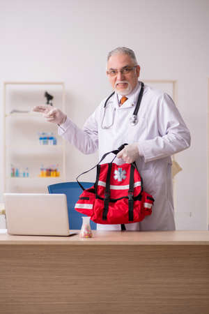 Old male doctor in first aid conceptの写真素材