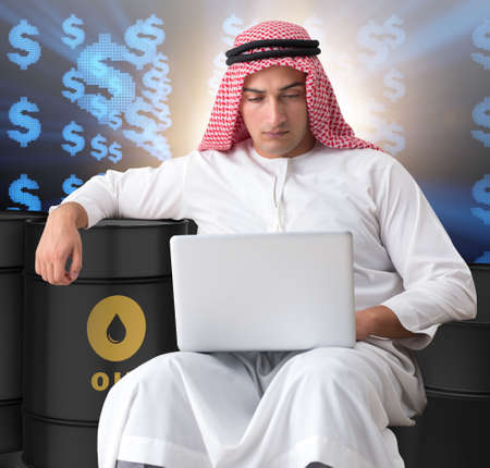 Arab businessman trading crude oil on laptopの写真素材