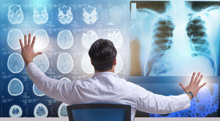 Male doctor looking at MRI scans