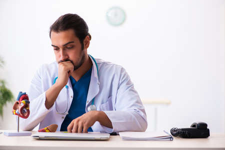 Young male doctor cardiologist working in the clinicの写真素材