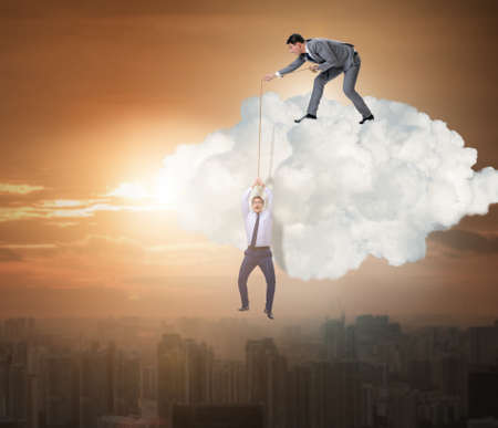 Businessman saving colleague by pulling rope