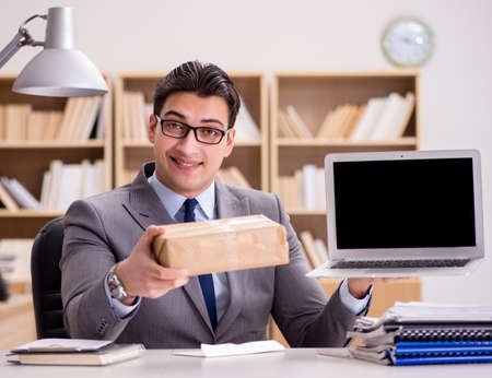 Businessman receiving parcel in the officeの写真素材