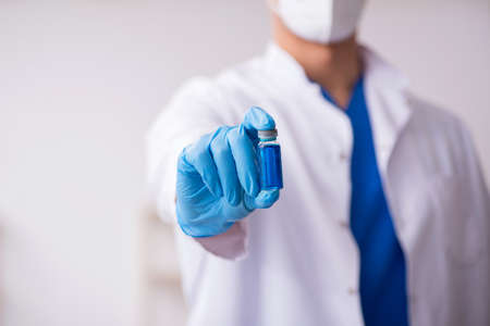 Young male doctor in vaccination conceptの写真素材