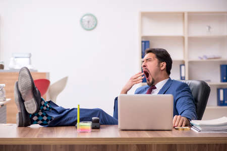 Young male employee sitting at workplaceの写真素材