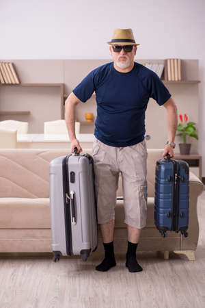 Old man preparing for trip at homeの写真素材