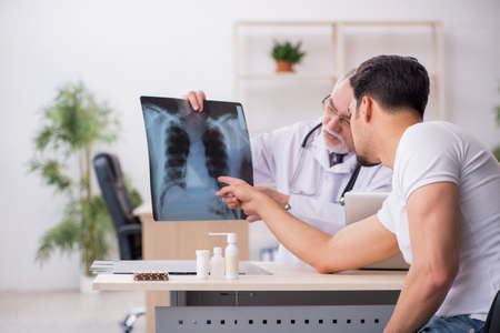 Young male patient visiting old male doctor radiologist
