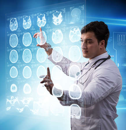 Male doctor studing x-ray image of MRI scan
