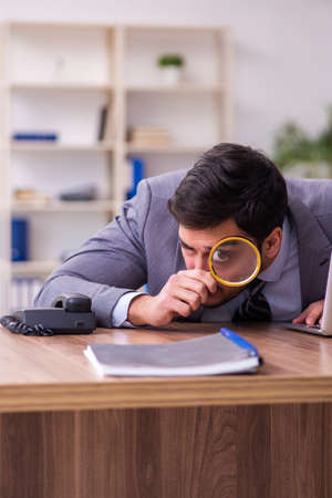 Young handsome auditor working in the officeの写真素材