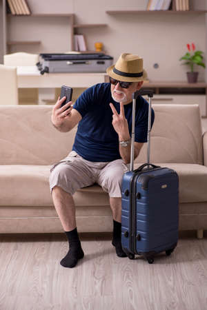 Old man preparing for trip at homeの写真素材