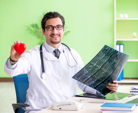 Doctor radiologist looking at x-ray scan in hospitalの写真素材