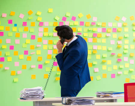 Businessman with many conflicting prioritiesの写真素材