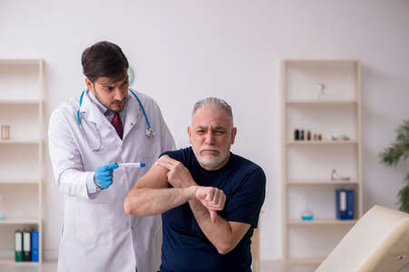 Old male patient visiting young male doctor in vaccination concept