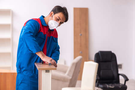 Young male carpenter working in the office during pandemicの写真素材