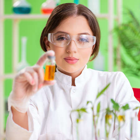 Beautiful female biotechnology scientist chemist working in labの写真素材