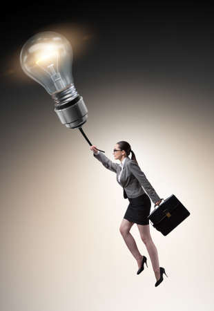 Businessman flying on lamp balloonの写真素材