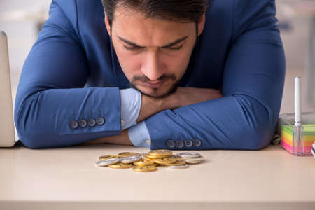 Young man earning money via Internet in cryptocurrency conceptの写真素材