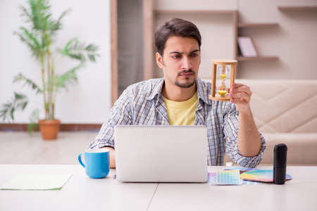 Young male freelancer working from house