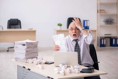 Old male employee in brainstorming conceptの写真素材