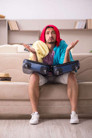 Young man preparing for trip at homeの写真素材
