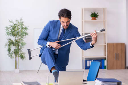 Young male employee after accident at workplaceの写真素材