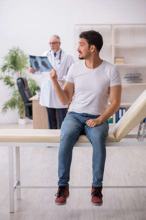 Young male patient visiting old male doctor radiologistの写真素材