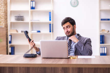 Young handsome businessman employee working in the officeの写真素材