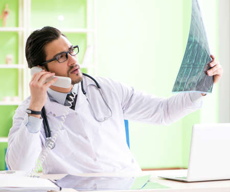 Doctor radiologist looking at x-ray scan in hospital