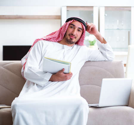 Arab man working at home on his workの写真素材