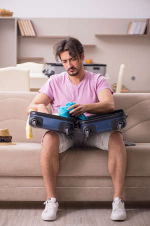 Young man preparing for trip at homeの写真素材