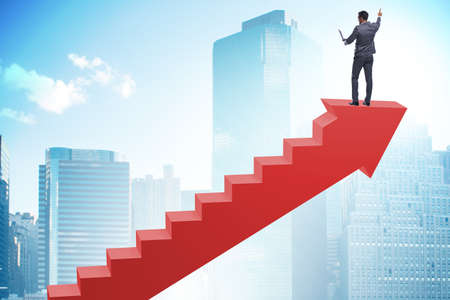 Businessman climbing career ladder in business conceptの写真素材