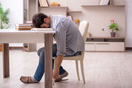 Young male student preparing for exams at homeの写真素材