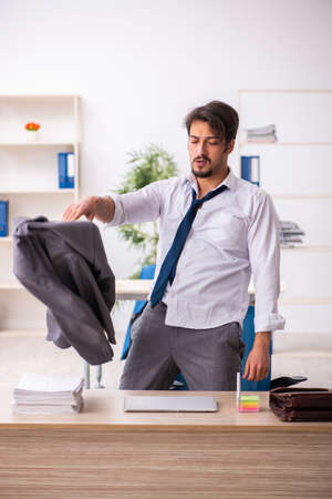 Young alcohol addicted employee sitting in the officeの写真素材