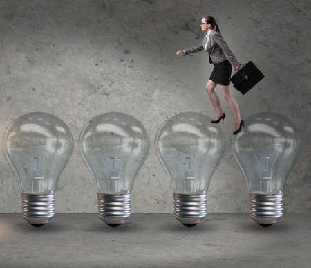 Businesswoman in new idea concept with light bulbの写真素材