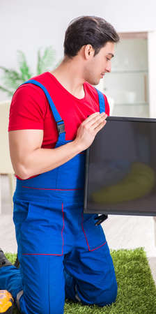 Professional repair engineer repairing broken tvの写真素材